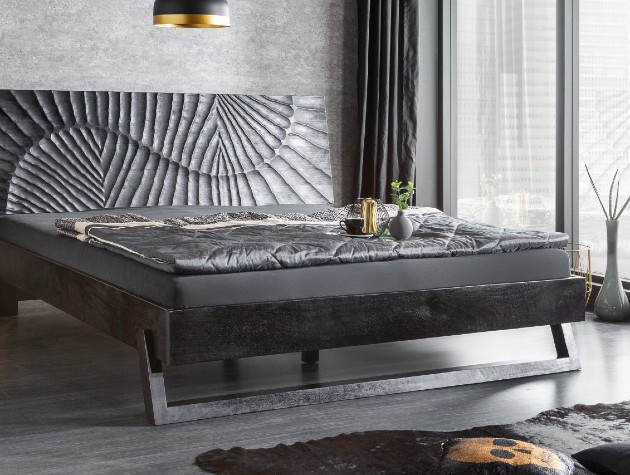 dark wood bed with patterned headboard