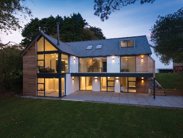 A modern home with large aluminium doors and windows shot at dusk
