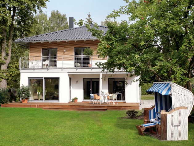 modern prefab home with balconies lawn and seating in front