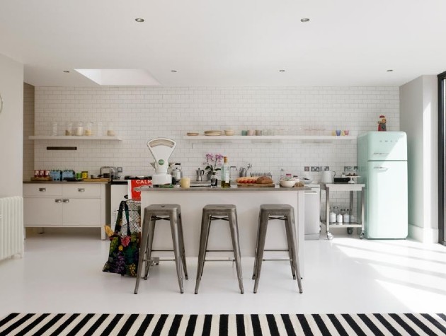 open plan kitchen with island metro tiles stools and striped rug