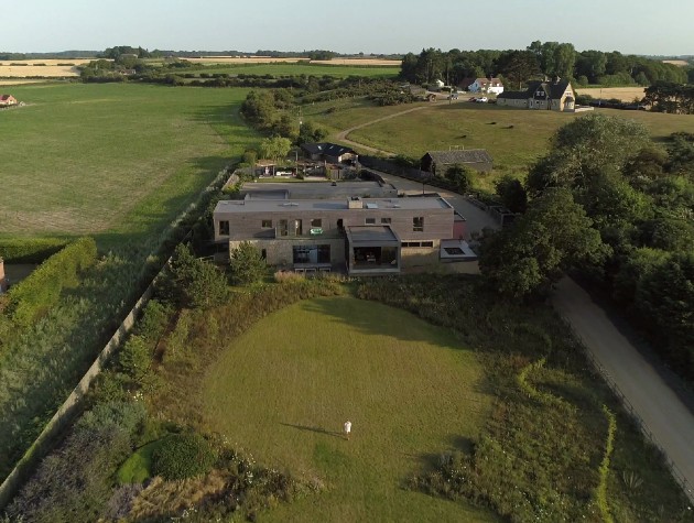 aerial view of modern new build home and grounds