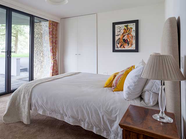 Master bedroom with double doors to its own terrace, neutral decor but pops of colour