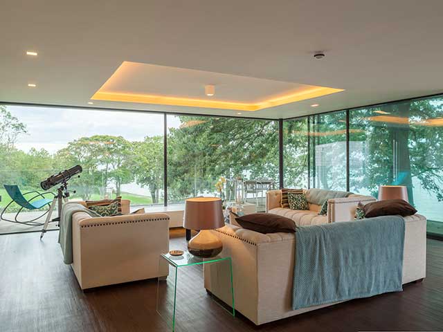Living area of Grand Designs Isle of Wight home overlooking garden space
