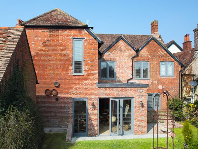 red brick detached home renovated with matching brickwork