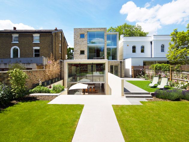 contemporary brick new build with large amounts of glass in the style of an Edwardian terrace like its neighbours 