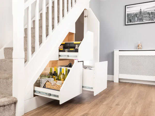 three drawers under stairs wood flooring carpeted stairs