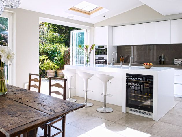 an open-plan kitchen-diner with bi-fold doors leading to the garden