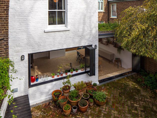 property to renovate brick floored patio plant pots large open window