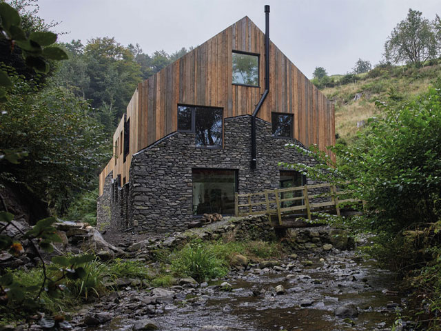 updated stone mill by babbling brook wooden bridge