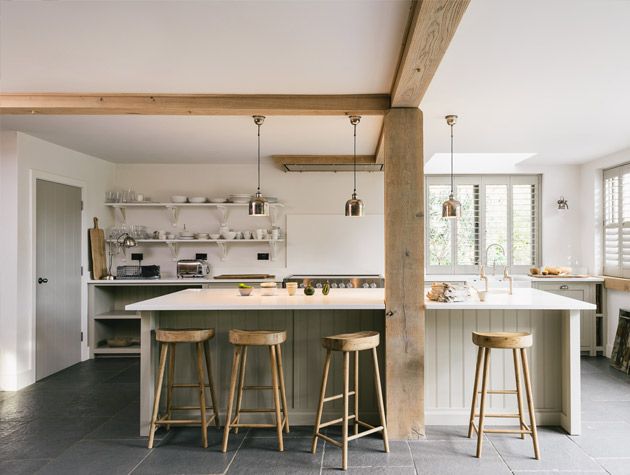 How to create a luxury kitchen on a budget white kitchen timber beams gold bar stools light green cladding 