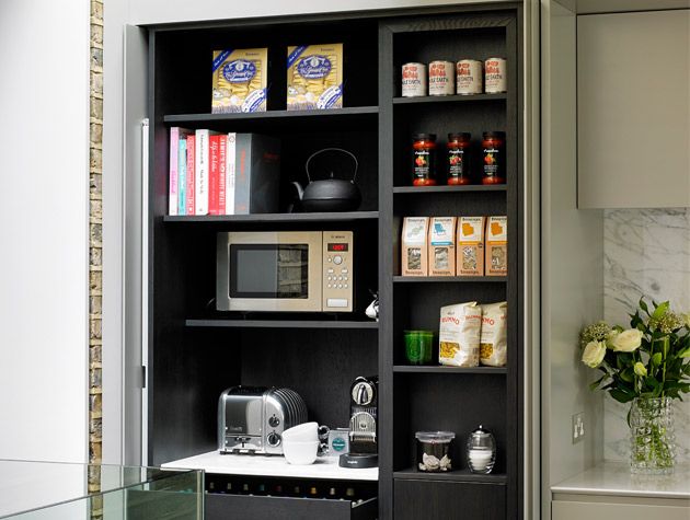 simplify your space. Hidden kitchen cupboard black shelves microwave cast iron tea pot teabags pasta sauces toaster white roses in vase