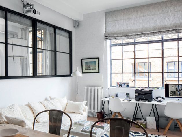 maximise natural light white walled warehouse apartment crittall style windows white sofa white desks
