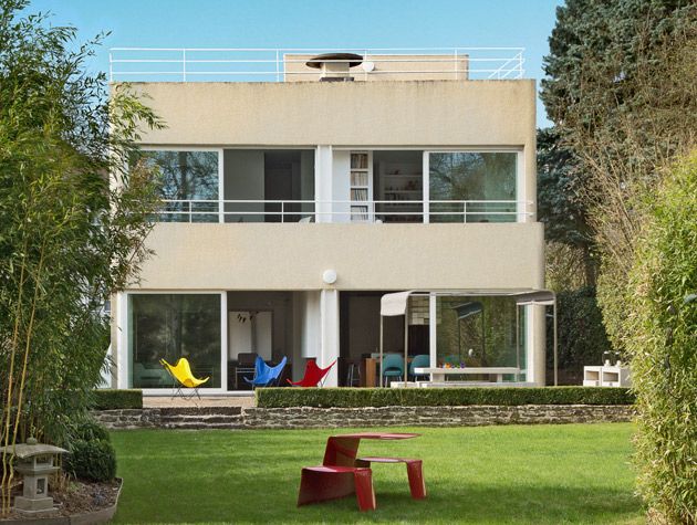 back of modern house colourful outdoor chairs 