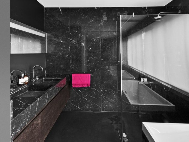 Black marbled bathroom double sink bath and shower pink towel 