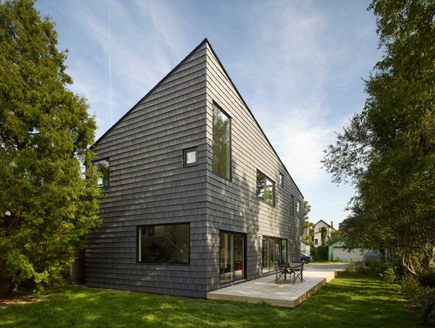 New build in Toronto sharp angled home exterior with black cladding 