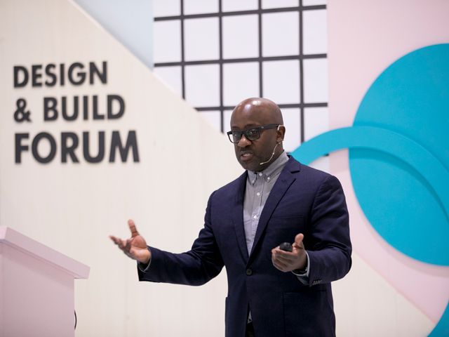 kunle barker speaking at grand designs live's design and build forum in 2018