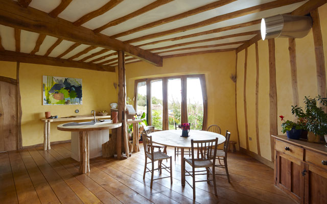Beamed walls and ceiling inside the Grand Designs Dugout house in Herefordshire