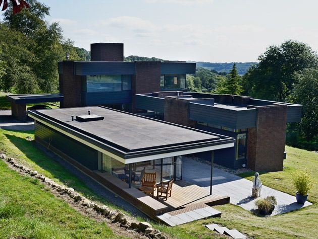 peter womersley home exterior on hillside cantilevered porch stone wall 