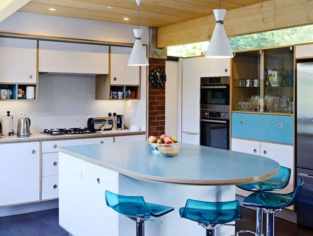 White cabinet kitchen recessed handles aquamarine blue barstools white cone pendant lighting