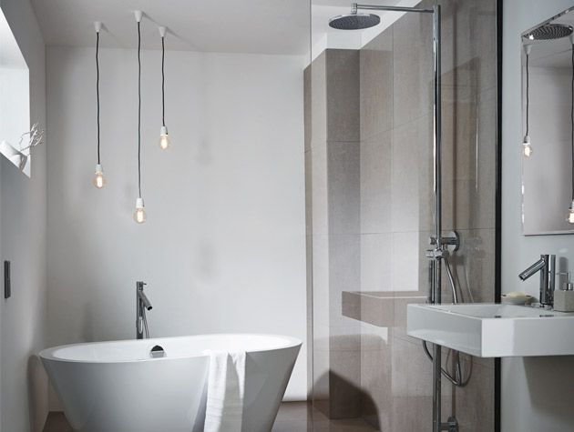 freestanding bath with modern pendant lights and neutral colour scheme