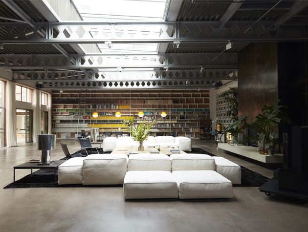 large living room with white sofas bookcase and large glazed roof lights non-residential building conversions