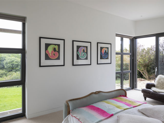 Three artworks by street artist Ben Eine in modern home with white walls