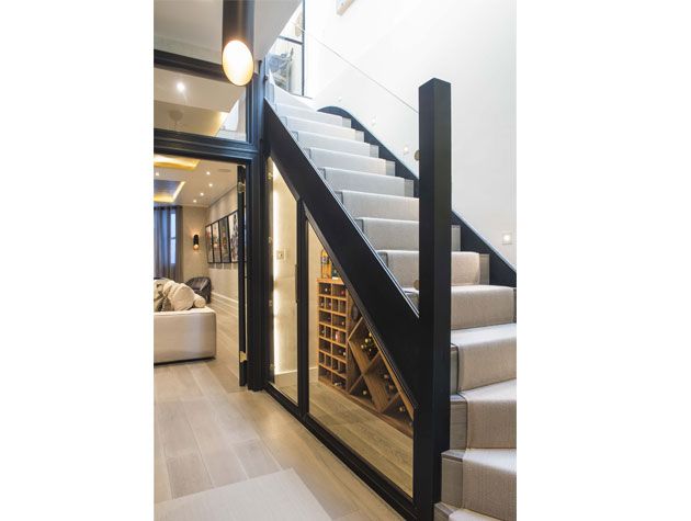 Built-in under staircase storage area -barbara-genda-home-improvements-granddesignsmagazine.com