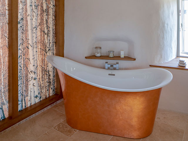 Copper freestanding bath tub with full length curtains Grand Designs Cob House