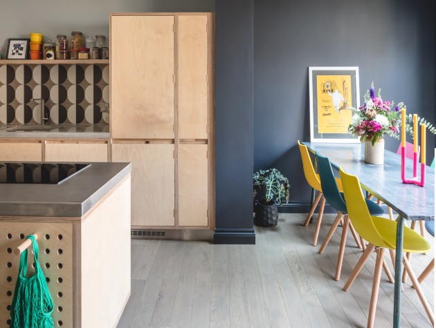 a kitchen with plywood units and a dining table and chairs