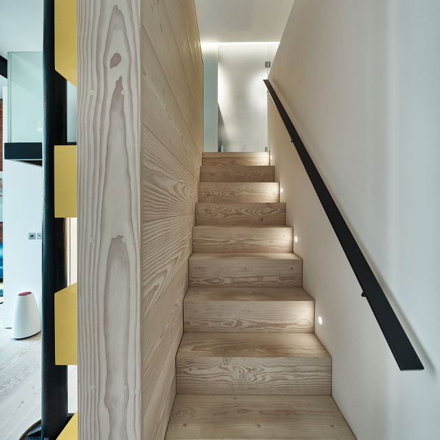 Pine staircase with diffused-effect lighting by Scott Donald Architecture 