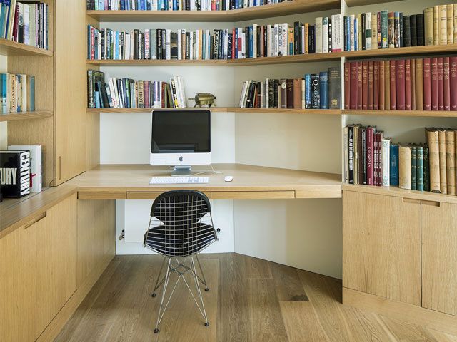 A home office and library with wooden desk and built-in storage units -studio-carver-home-improvements-granddesignsmagazine.com