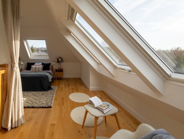 view of bed and windows in converted loft 