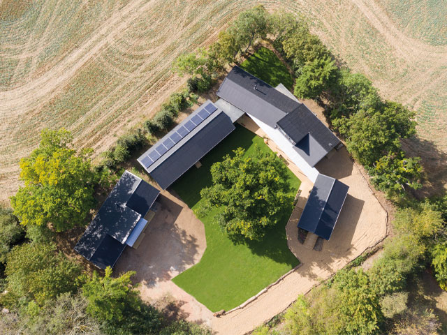 Building near trees: This horseshoe-shaped self-build in rural Suffolk is arranged around an oak tree