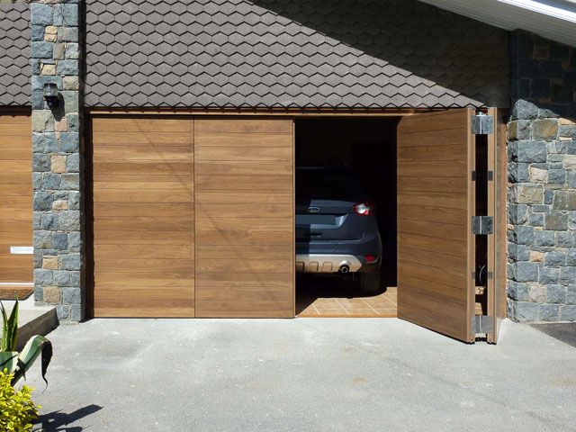 wood bifold garage doors in a driveway with Urbanfront jersey bifold parma