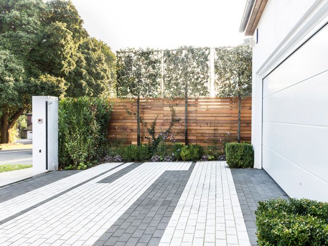 white and grey paving in a driveway with garage using Langlea Linear Embrace