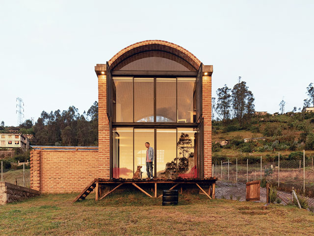 two storey bread oven brick house with elevated entrance and floor to ceiling glazing