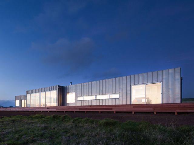 A single-storey linear prefab with aluminium cladding in a remote location on Phillip Island in Australia