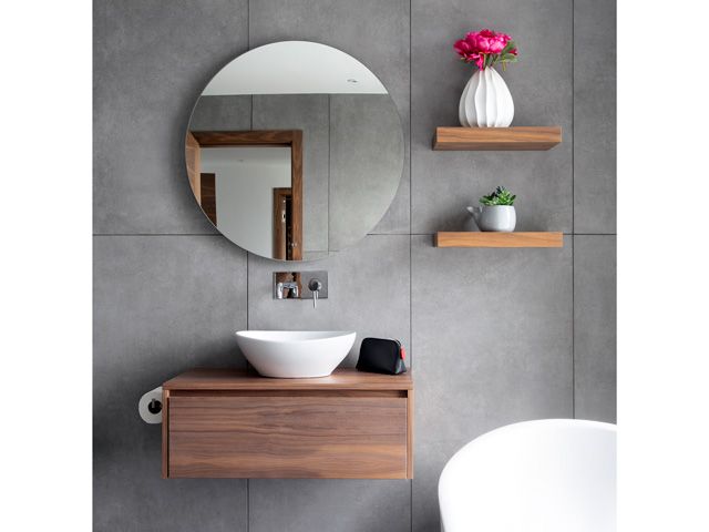 grey modern bathroom of the grand designs Galloway house with mirror cabinet vanity unit in walnut wood