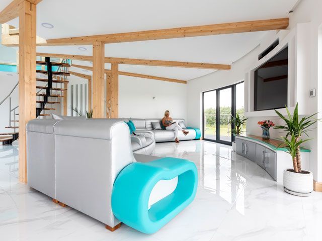 the silver, white and turquoise living room in the lincolnshire grand designs tv house featured in 2019 series of Grand Designs, on Channel 4, hosted by Kevin McCloud