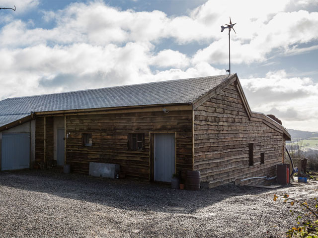 The-Cowshed-self-build-in-Somerset-uses-reclaimed-timber-and-north-facing-roof-tiles-made-from-recycled-plastic-bottle-tops-Photo-Matt-Chisnall-640