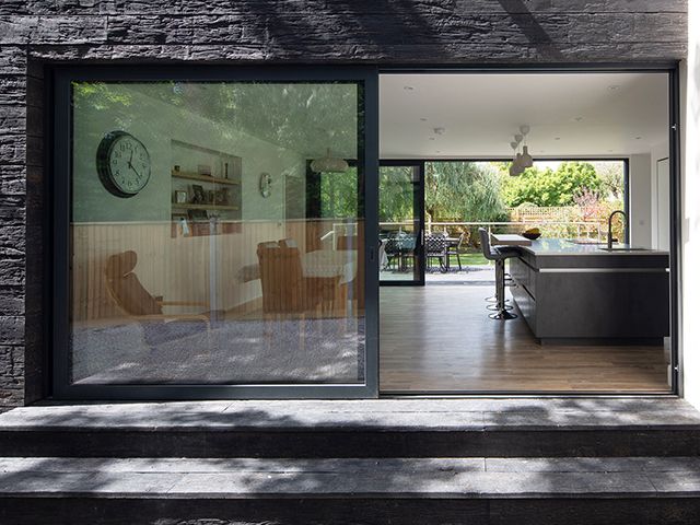 open plan kitchen diner with floor to ceiling windows that slide open to the garden