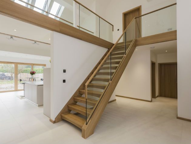 bespoke timber staircase with glass inserts in a modern open-plan family home