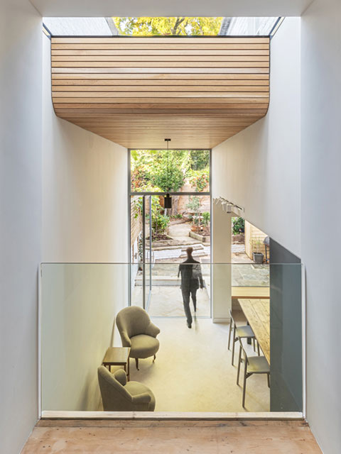 mezzanine level of extension interior with wood panelled ceiling - grand designs