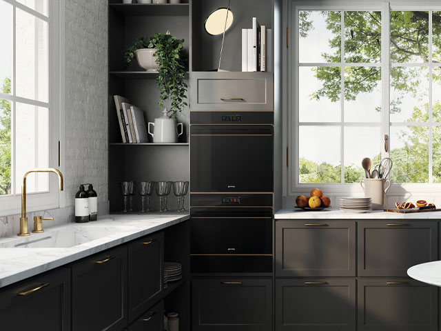 black smart oven from Smeg in a dark grey kitchen with marble worktops