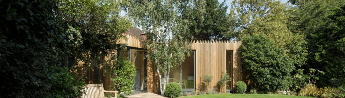 This feathered edge wooden garden building was built in red cedar around a silver birch. Photo: Tim Crocker