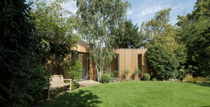 This feathered edge wooden garden building was built in red cedar around a silver birch. Photo: Tim Crocker