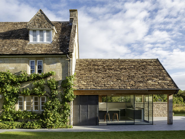 Charlie Luxton Design sensitively added to this listed Wiltshire house with a kitchen-diner extension. The roof pitch and reclaimed slates echo the original house, making for a neat transition, while expansive glazing is used to not draw focus rom these traditional materials. Photo: Mark Bolton 