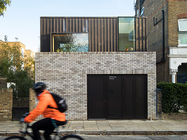 small self build house built above a garage with steel roof extension in london difficult plots