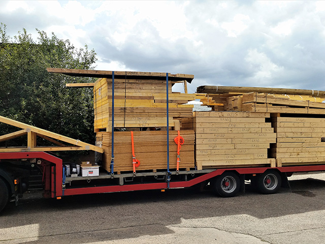 self build affordable house kit arriving on a truck 