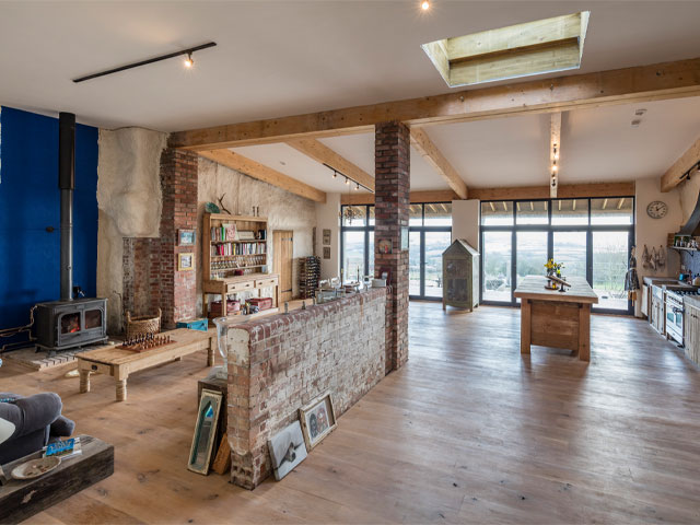 Inside the huge open plan living/dining space of the Grand Designs cowshed property conversion in Somerset